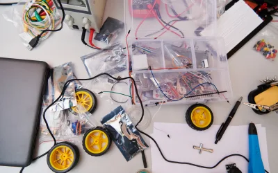 Various components and installations for robot fabrication fill the space, representing the intricate blend of technology, engineering, and innovation involved in the development and assembly of advanced robotic systems.